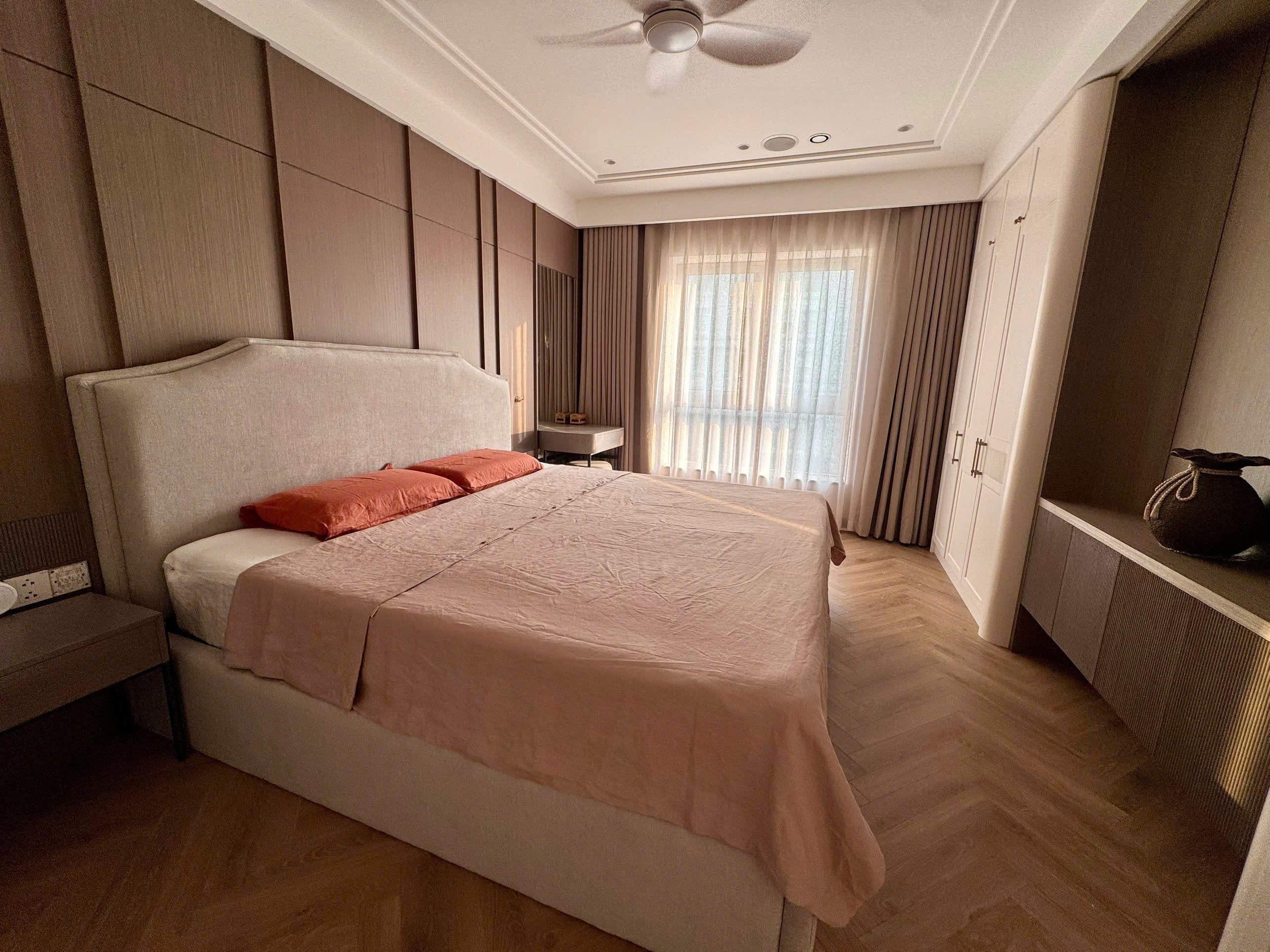 Dusty pink French linen duvet cover set on a king bed in a warm Hanoi bedroom with herringbone wood floors and terracotta pillows — SCANDALINEN Real Homes