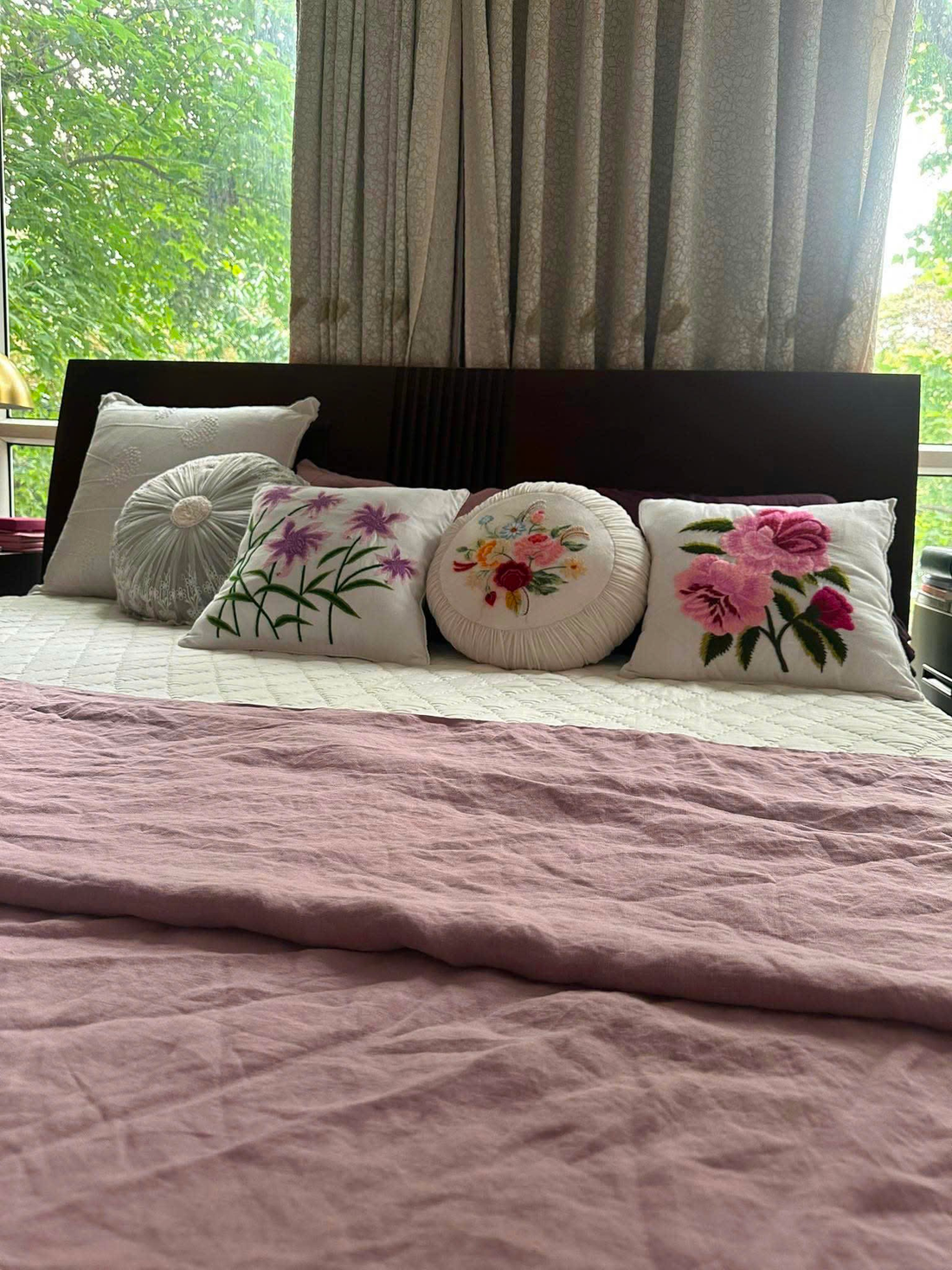 Bedroom styled with Purple French Linen Duvet Cover and embroidered floral cushions, natural light from window