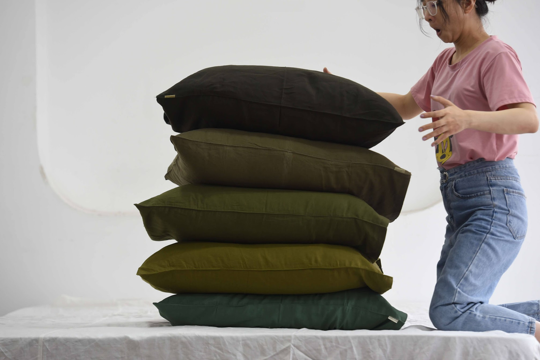Stack of French linen pillowcases in green tones — SCANDALINEN size guide for Australia