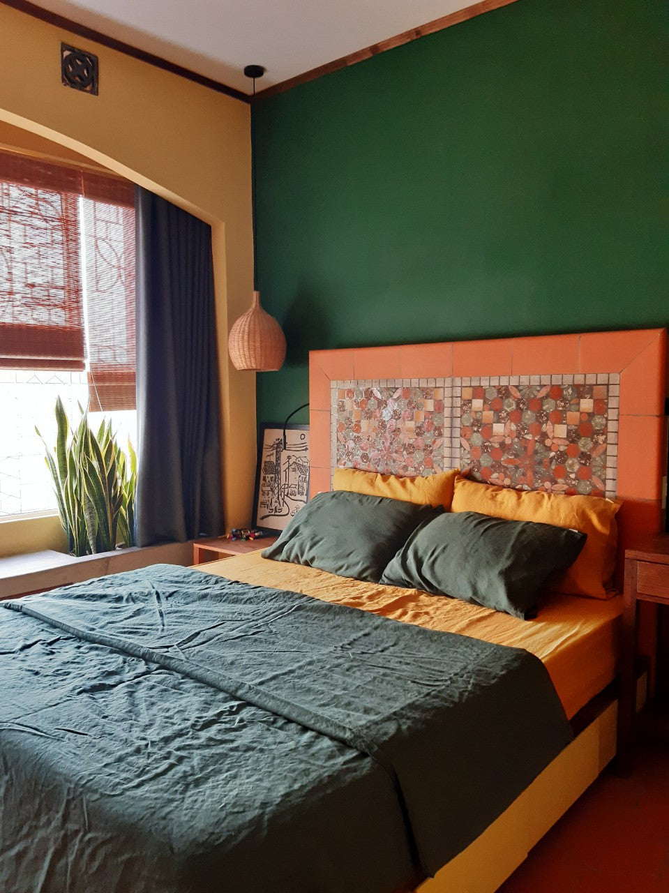 Teal SCANDALINEN French linen bedding in a colourful Indochine bedroom with mosaic headboard and forest green walls