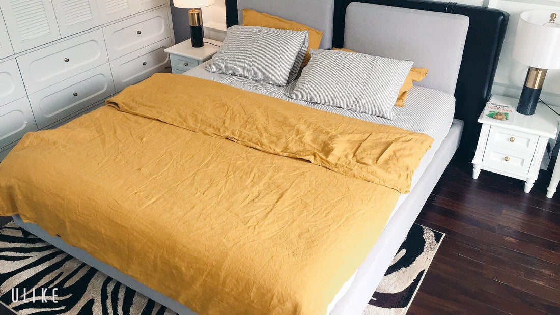 Customer bedroom with mustard yellow French linen duvet cover - SCANDALINEN
