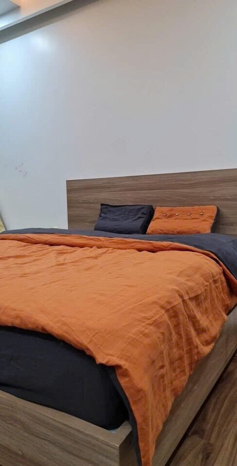Terracotta French linen duvet cover on a wooden bed — SCANDALINEN real customer bedroom