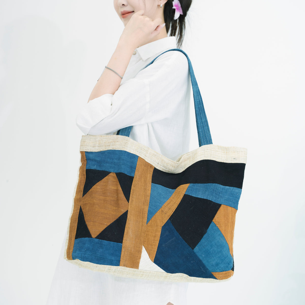 Handmade Hmong brocade tote bags with traditional geometric patterns and natural indigo dye