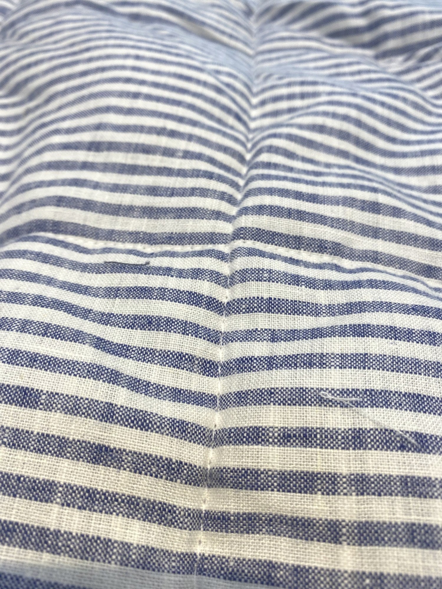 Navy pinstripe French linen quilted blanket on a bed, 100% European flax - SCANDALINEN