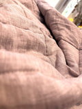 Terracotta Clay French linen quilted blanket on a bed, 100% European flax, stonewashed - SCANDALINEN