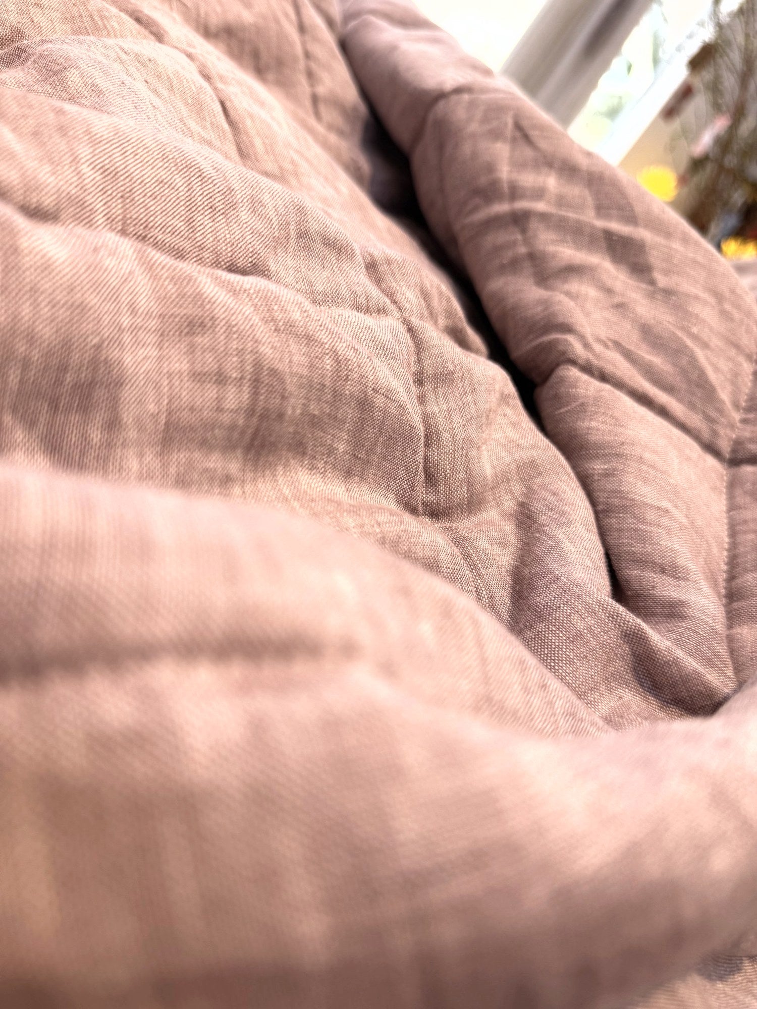 Terracotta Clay French linen quilted blanket on a bed, 100% European flax, stonewashed - SCANDALINEN