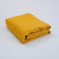 Yellow French linen top sheet on a bed, 100% European flax, stonewashed - SCANDALINEN