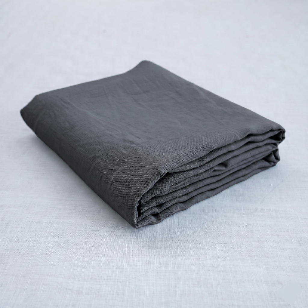 Dark charcoal French linen flat sheet on a bed, 100% European flax, stonewashed - SCANDALINEN