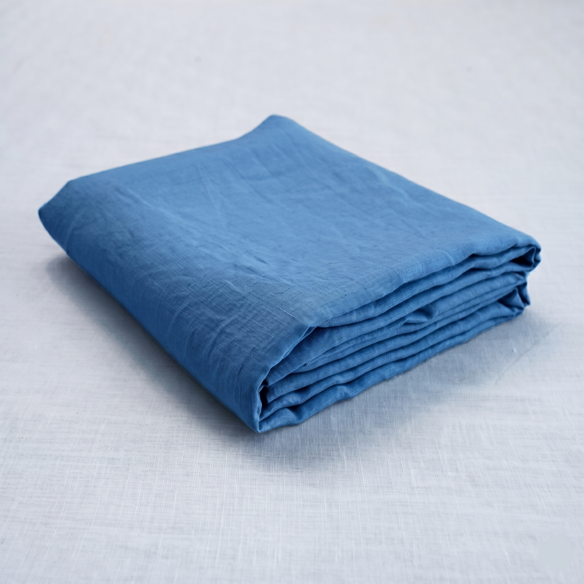 Navy French linen top sheet on a bed, 100% European flax, stonewashed - SCANDALINEN