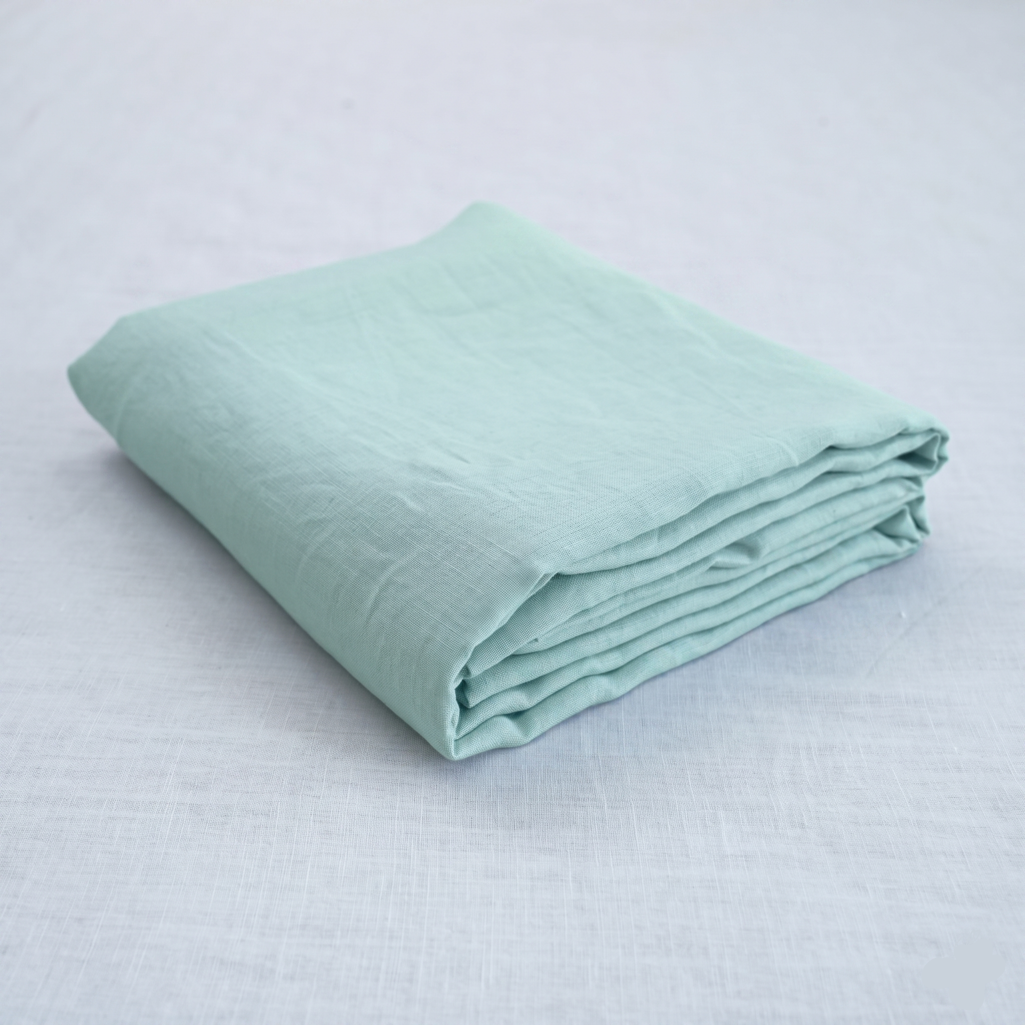 Mint French linen flat sheet on a bed, 100% European flax, stonewashed - SCANDALINEN