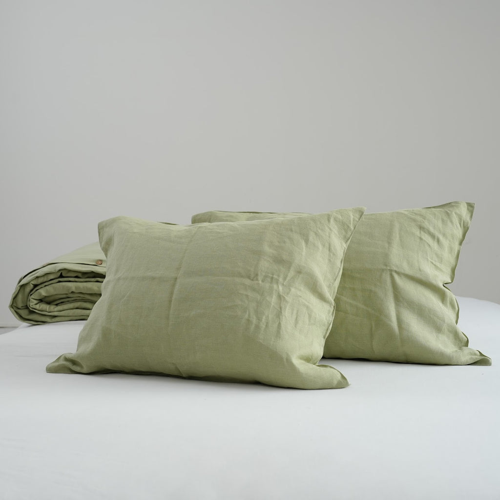 Avocado green French linen pillowcases on a bed, 100% European flax, stonewashed - SCANDALINEN