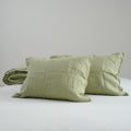Avocado green French linen pillowcases on a bed, 100% European flax, stonewashed - SCANDALINEN