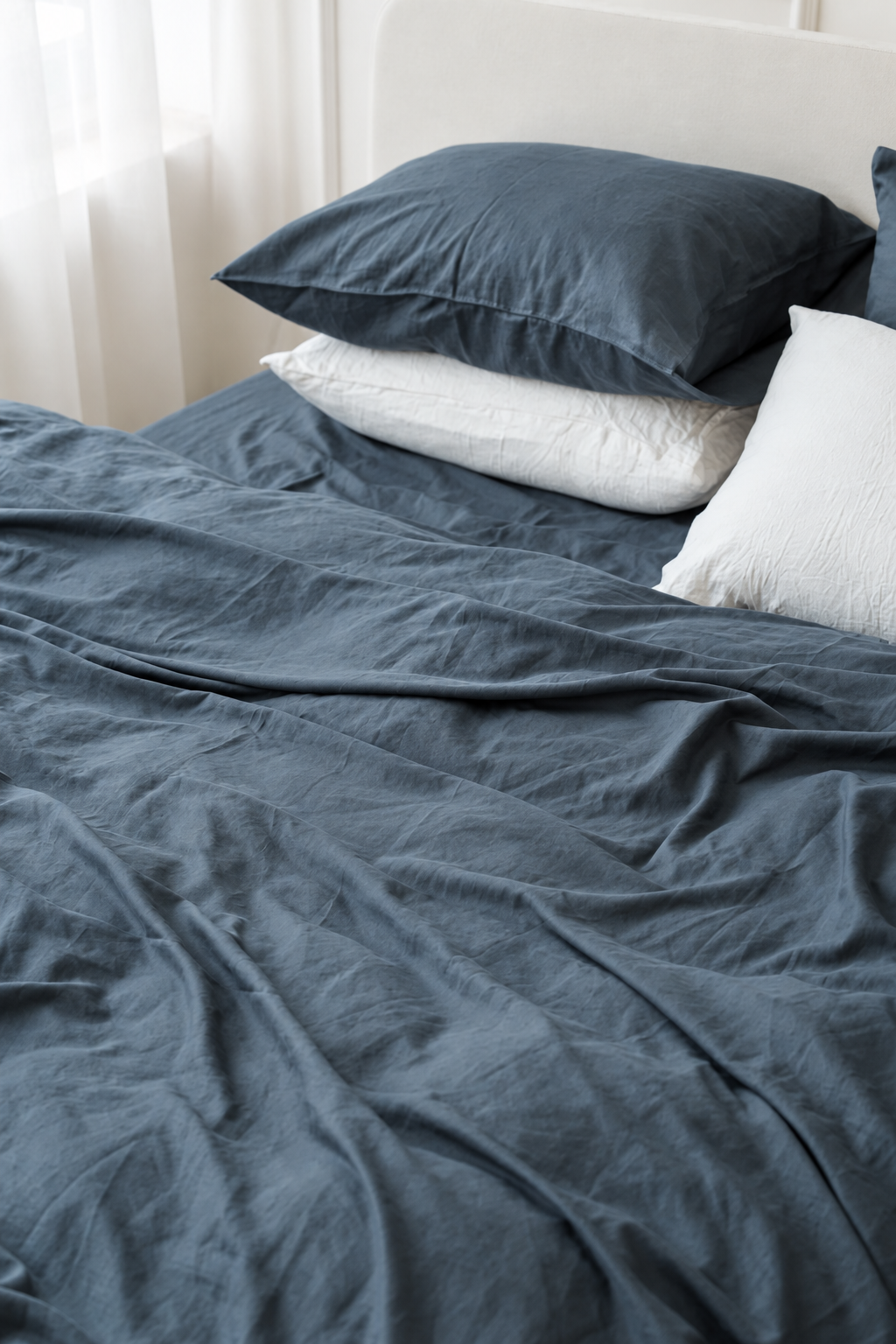 Close view of the grey bamboo linen duvet cover, with visible seams and soft folds in natural light