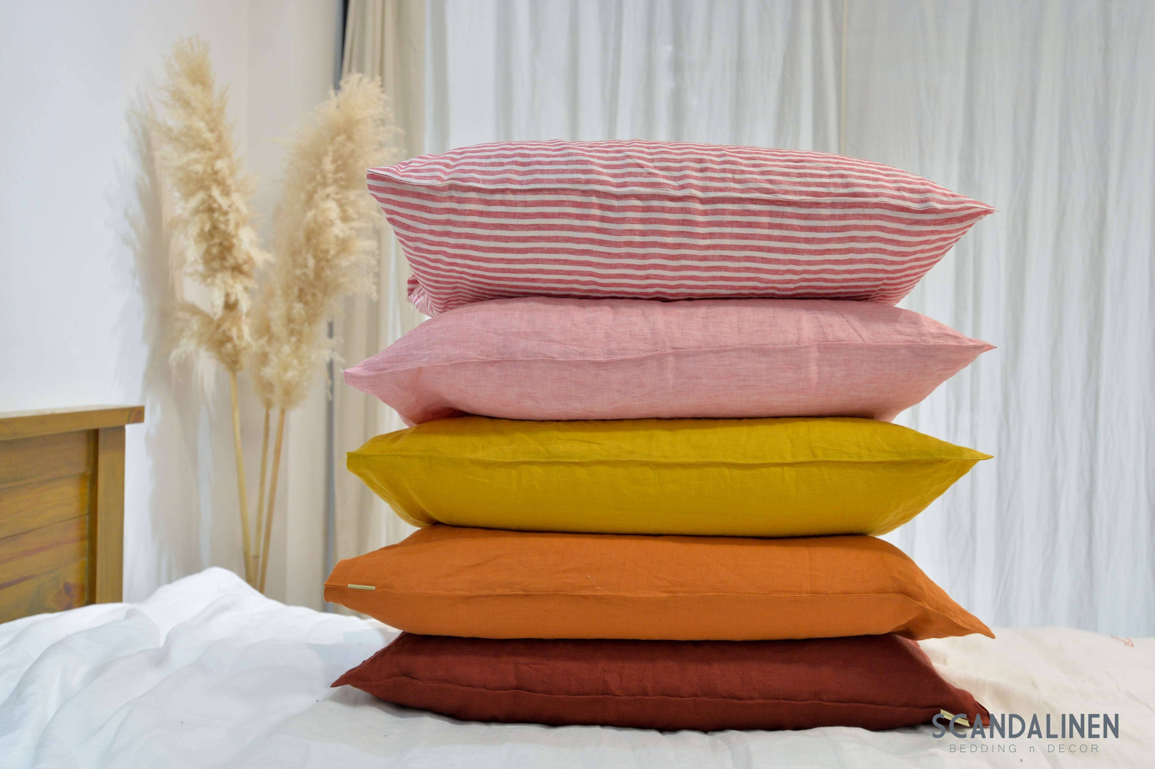 Red striped French linen pillowcase on a bed, 100% European flax, stonewashed - SCANDALINEN
