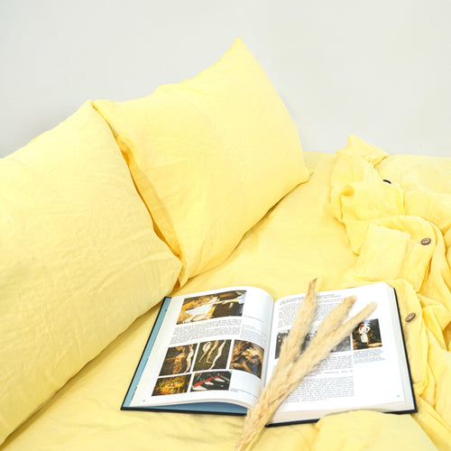 Butter yellow French linen flat sheet on a bed, 100% European flax, stonewashed - SCANDALINEN