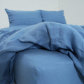 Denim blue French linen flat sheet on a bed, 100% European flax, stonewashed - SCANDALINEN