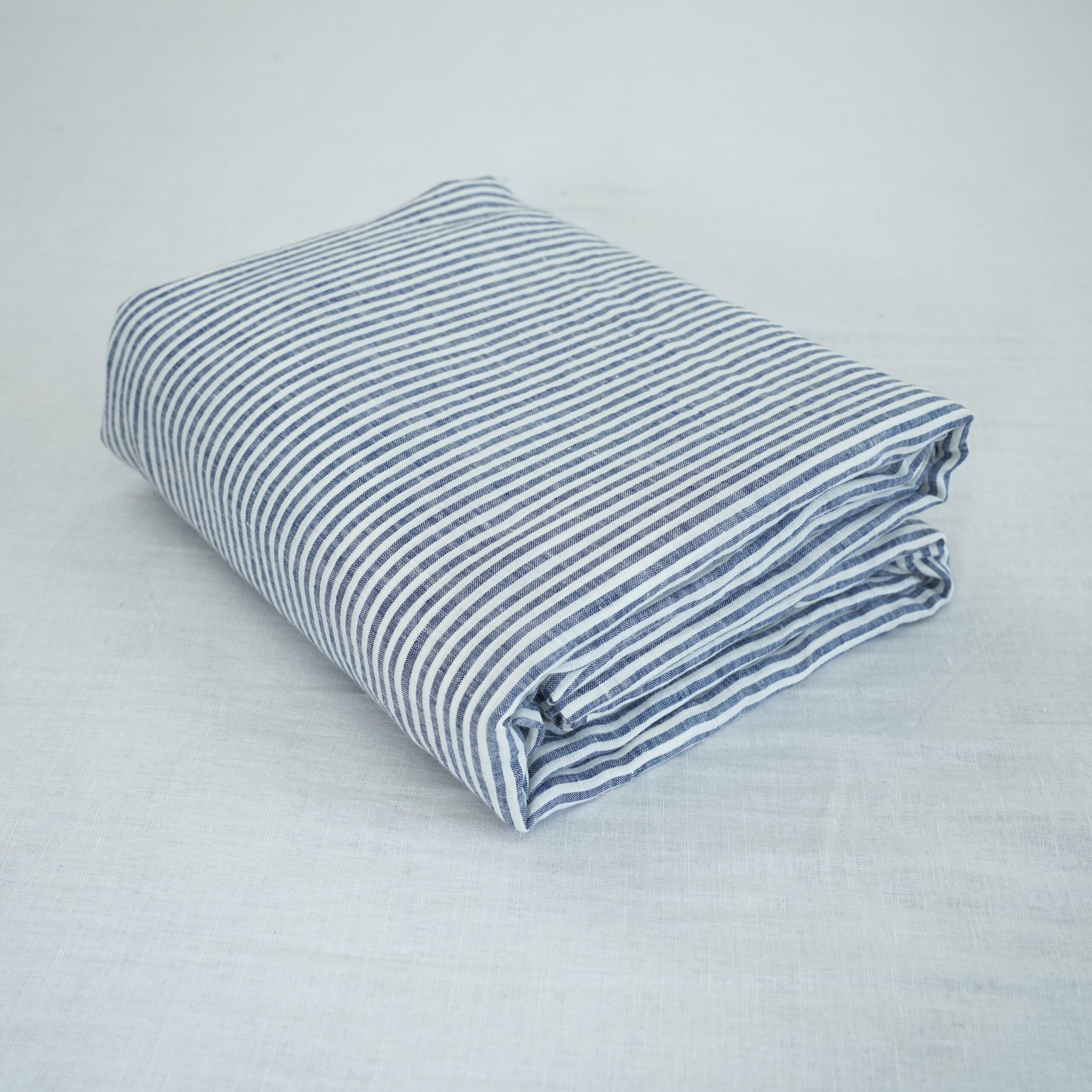 Navy Striped French linen top sheet on a bed, 100% European flax, stonewashed - SCANDALINEN