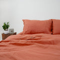 Rust French linen flat sheet on a bed, 100% European flax, stonewashed - SCANDALINEN