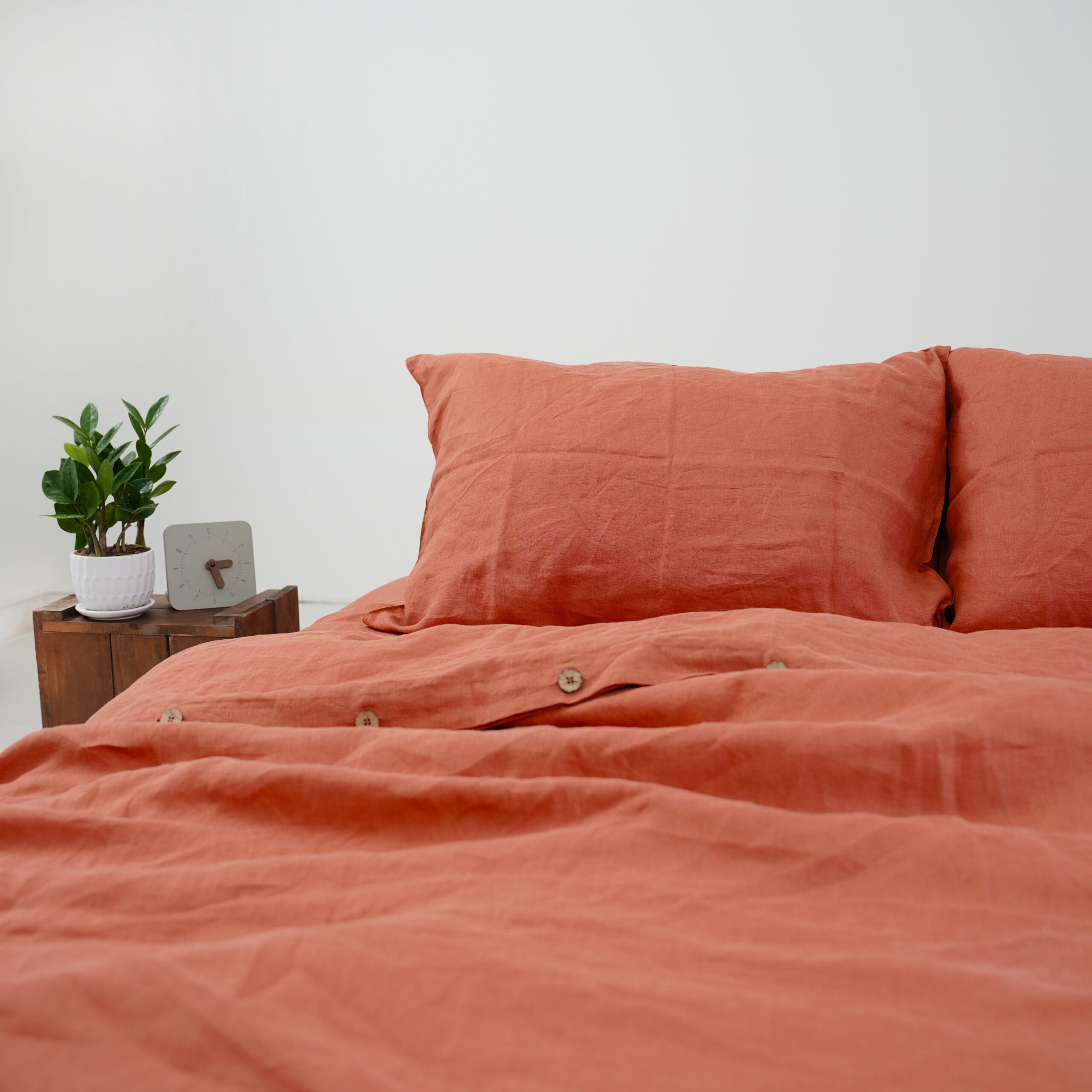 Rust French linen flat sheet on a bed, 100% European flax, stonewashed - SCANDALINEN