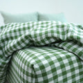 Green grid gingham French linen flat sheet on a bed, 100% European flax, stonewashed - SCANDALINEN