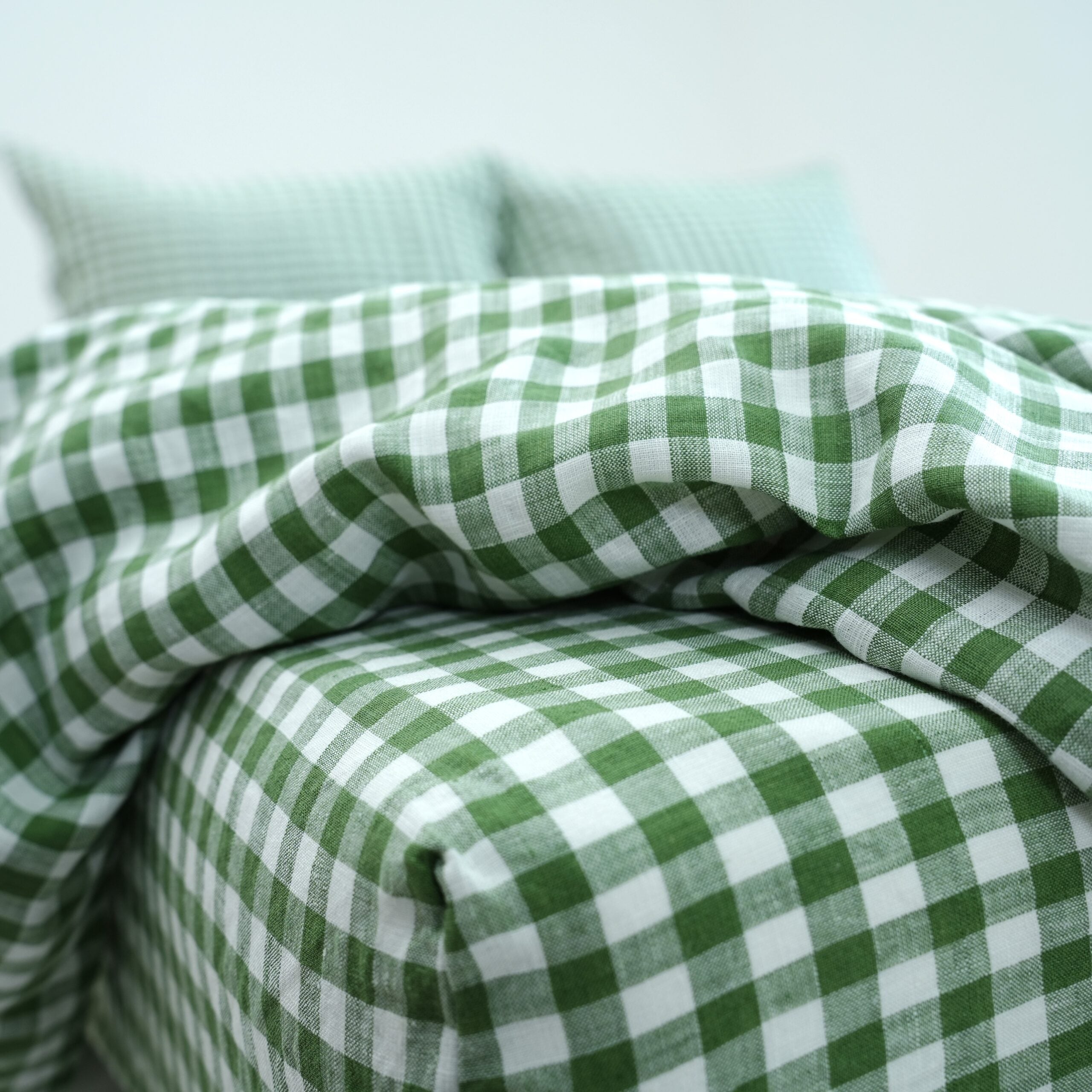 Green grid gingham French linen flat sheet on a bed, 100% European flax, stonewashed - SCANDALINEN