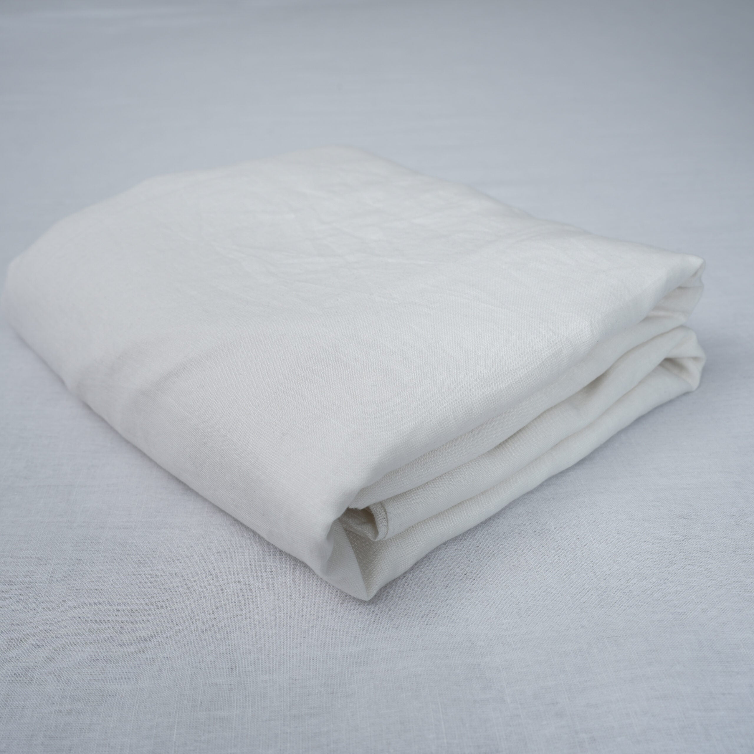 White French linen flat sheet on a bed, 100% European flax, stonewashed - SCANDALINEN