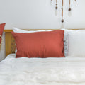 Red French linen pillowcase on a bed, 100% European flax, stonewashed - SCANDALINEN